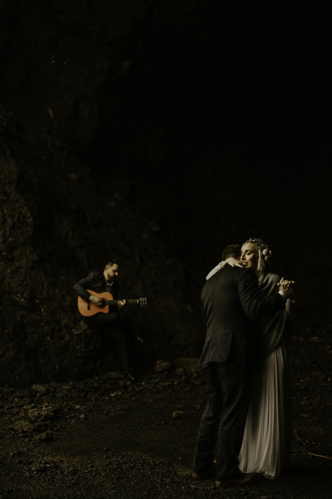Iceland elopement couple's first dance with live acoustic music in Yoda cave in southern Iceland. 