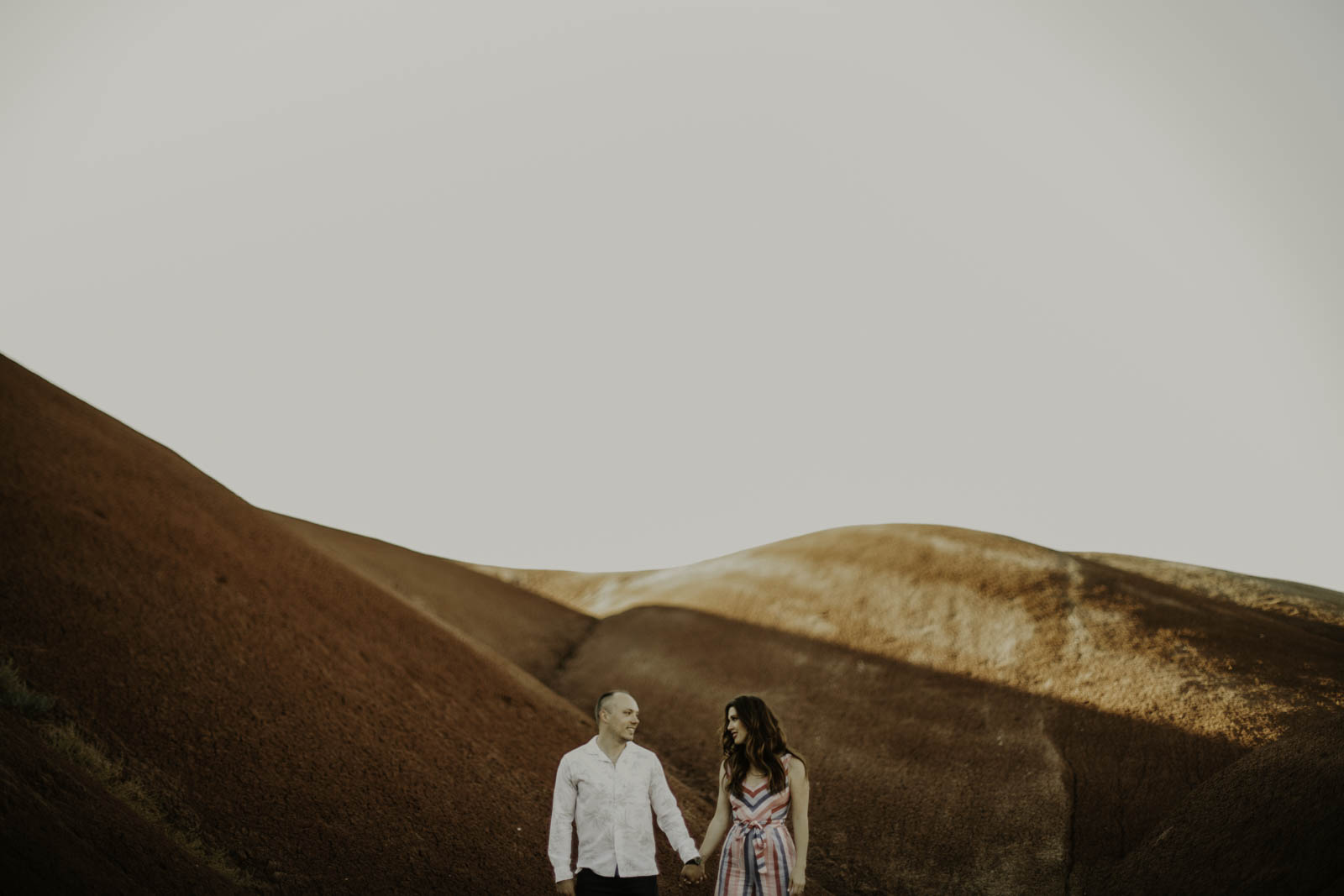 Couple holding hands in desert