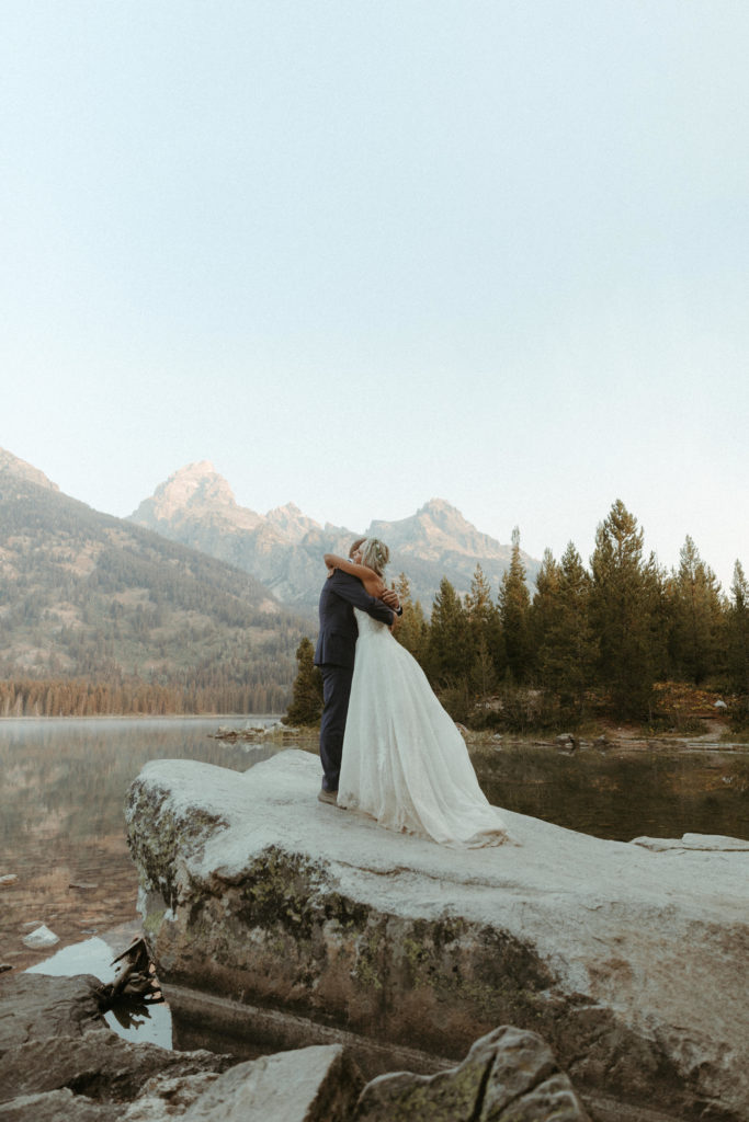 Bride and groom eloping in Grand Teton National park at sunrise.